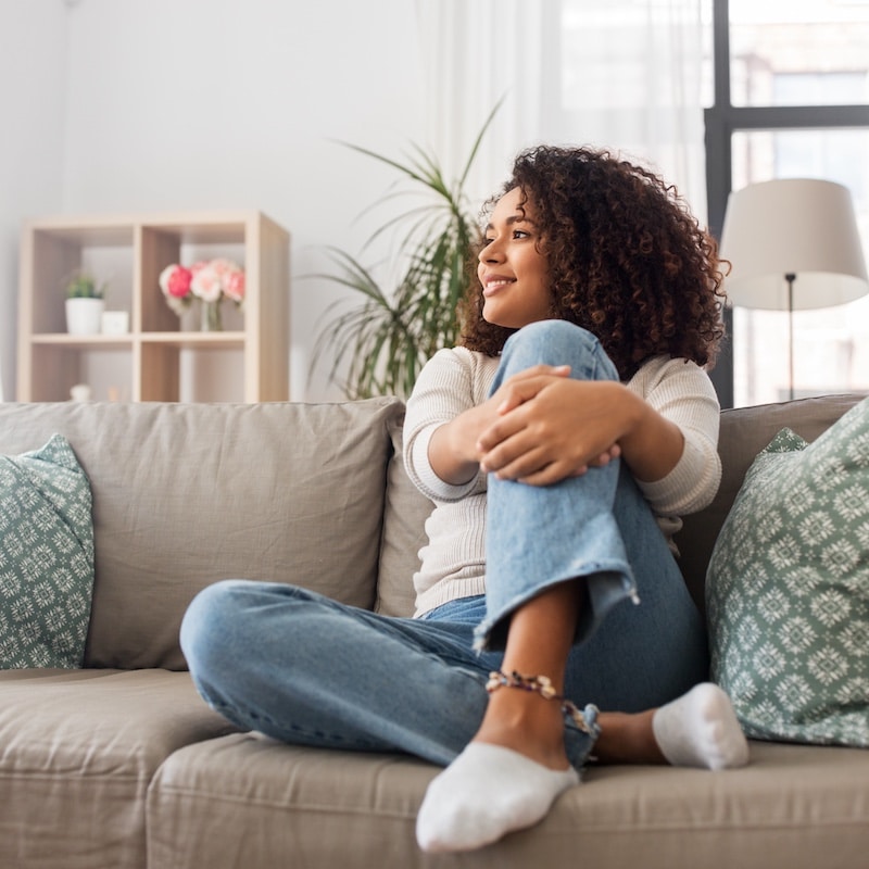 happy african american young woman at home whole home odor removal